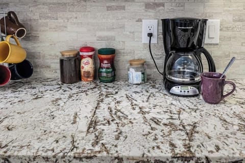 No need to worry about coffee! Our automatic drip coffee maker comes with coffee, sugar, and Coffee-mate, plus some Folgers instant decaf for your convenience. Enjoy a fresh cup anytime!