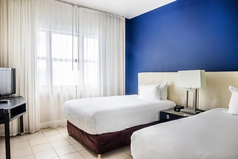 Stretch out in a calming blue room with balcony access.
