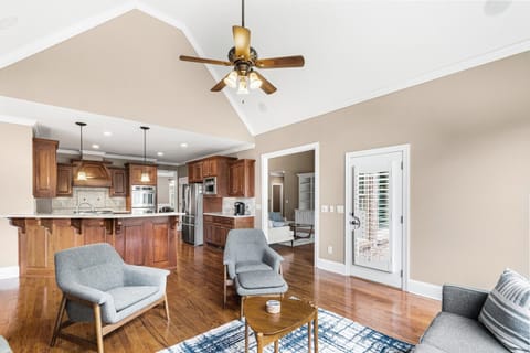 Family room with vaulted ceilings and ceiling fan.