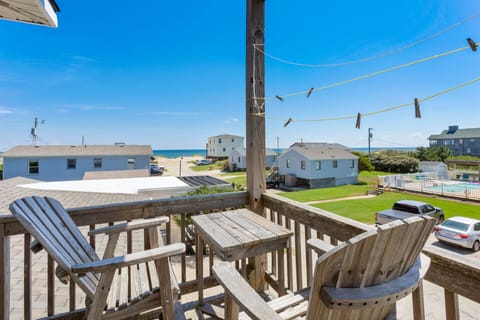 Relax with a cool drink in the Outdoor Sitting Area with views of the ocean!