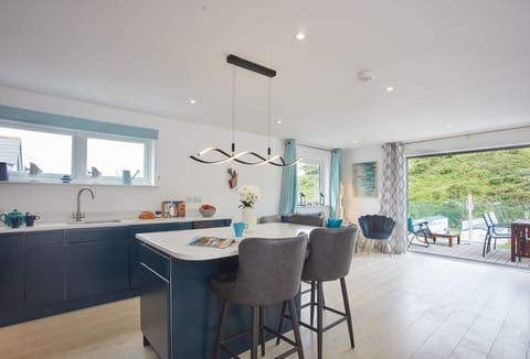 Anneth Lowen, Polzeath. Well equipped kitchen area with contemporary units, American Fridge/freezer, electric oven and ceramic hob, microwave and dishwasher