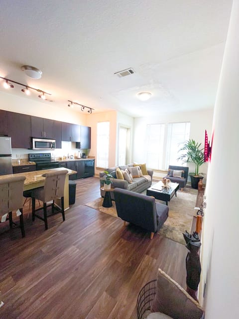 Couch pulls out to Queen foam mattress, each grey chairs unfolds into twin bed.