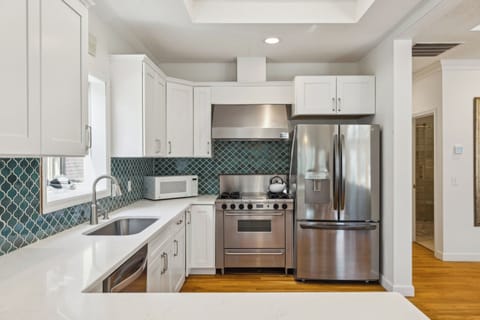 Fully stocked kitchen with all stainless steel appliances.