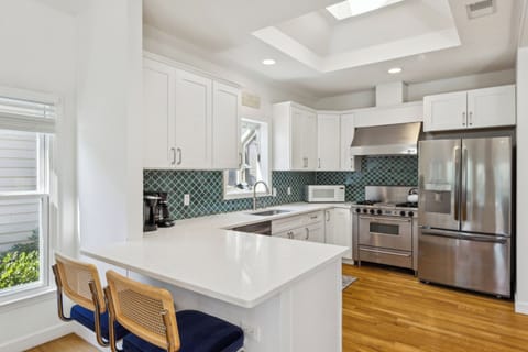 Fully stocked kitchen with all stainless steel appliances.