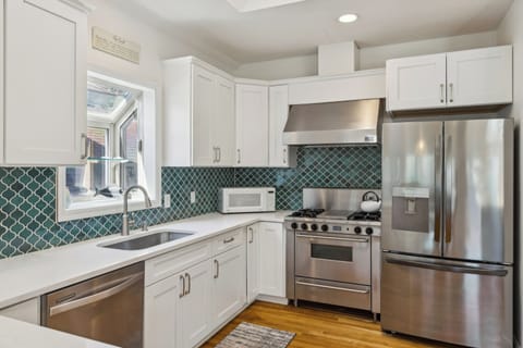 Fully stocked kitchen with all stainless steel appliances.