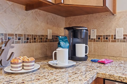 Fully Equipped Kitchen with beautiful stone countertops, stainless steel Wolf appliances, sub zero fridge, and bar seating for 3