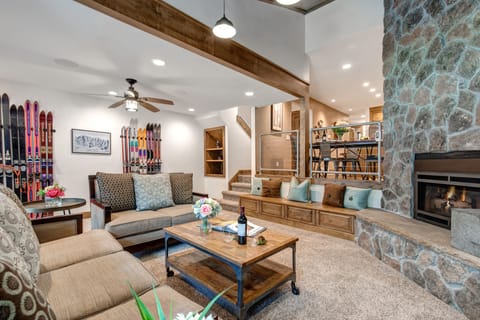 Living Room with cozy gas fireplace, Smart TV, plush furnishings, vaulted ceiling, and patio access.