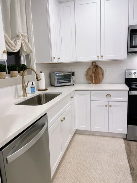 Farm sink and quartz countertops with a new toaster oven.
