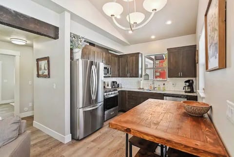 Fully stocked kitchen with coffee maker, toaster, utensils, and crockpot.