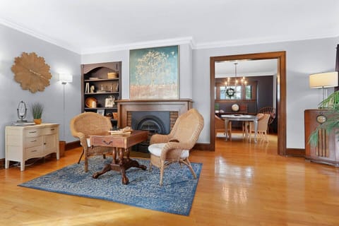 The spacious living room includes a game table flanked by a cozy gas fireplace.  Opposite this area is additional seating and a 50" TV.