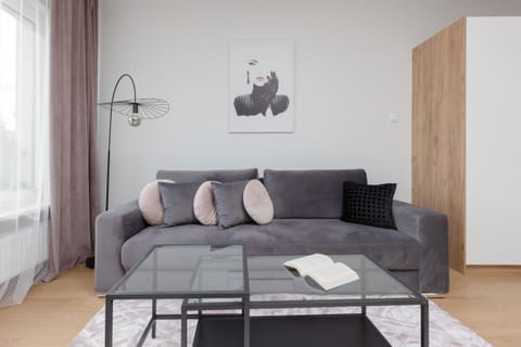 A stylish living room with a comfortable sofa, neutral tones, and modern décor, creating a relaxing atmosphere.
