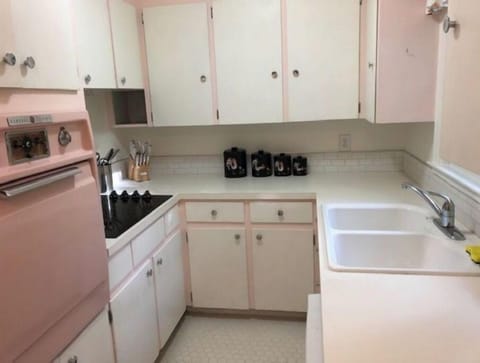 Vintage kitchen with original pink oven! New floor, counters and sink.