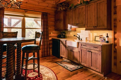 Kitchenette with farm sink, refrigerator, and microwave.