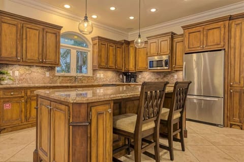 Spacious, fully equipped kitchen featuring a wine cooler, wet bar, and canal-front setting in a luxury Marathon FL waterfront vacation home.