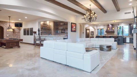 Luxury couches near the bar & pool table w/ TV for entertainment for everyone