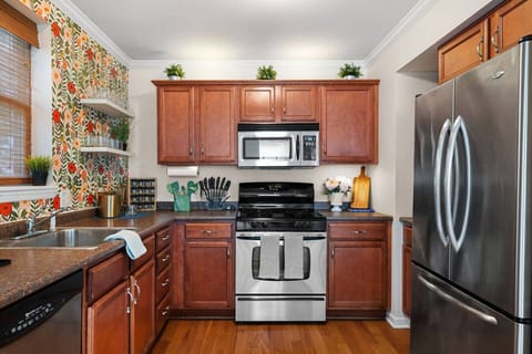 Vibrant Walls, Fully Stocked – A colorful kitchen that’s as functional as it is fun, complete with full-size appliances and all the essentials to cook or reheat with ease.