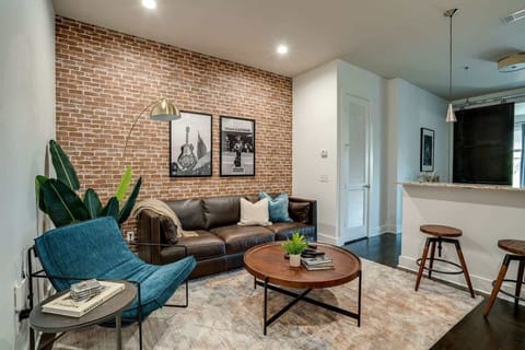 Urban style living room with designer furnishings and flat screen TV.