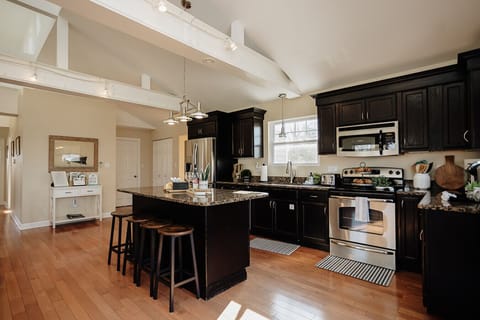 The kitchen island provides comfortable seating for up to four guests.