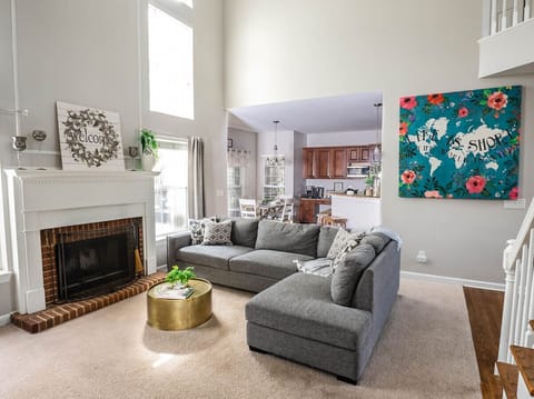 There`s plenty of breathing room in this 2 story living room with ceiling fan.