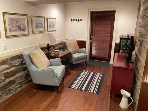 The other end of the 2nd BR with TV, 2 comfortable chairs and 2nd exit door