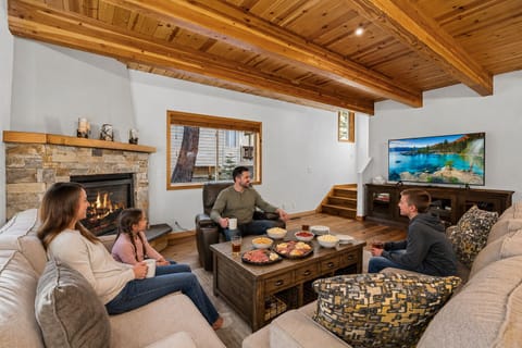 Gather around the warm fireplace with your favorite people, enjoying cozy evenings filled with good food, laughter, and relaxation in this inviting living space designed for creating memories together.