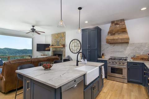 Open concept Chefs Kitchen with large island & Den with Mountain views