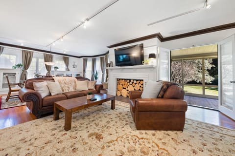 Spacious living room with open doors to screened-in porch.