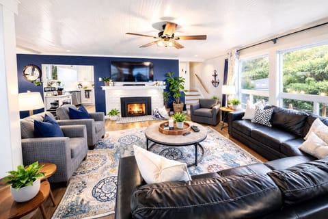 Bright coastal living rm with ocean views and cozy fireplace. A VRBO must stay!