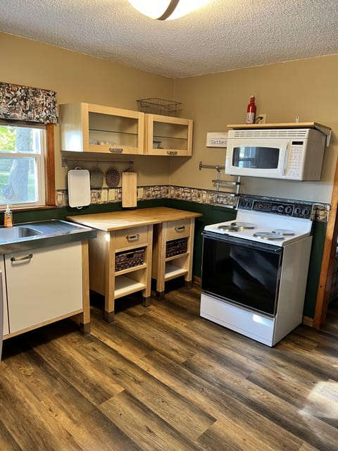 Kitchen area with basic appliances and new fridge/freezer.