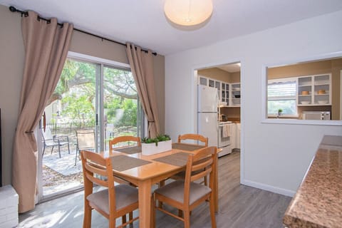 Coffee bar, wine bar. This built in credenza serves you all day long! Perfectly located off the kitchen, your dining area includes a spacious countertop that could be used as a buffet. The view of the outdoor patio and soft lighting further enhances the