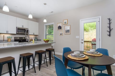 Fully stocked kitchen, eat-in island, and dinning table for eight people. 