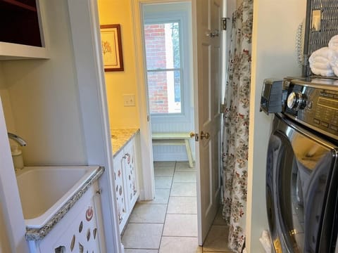 Hall bath has laundry and shower