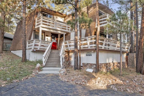 Welcoming cabin entry surrounded by towering pine trees, offering fresh mountain air and a peaceful forest setting—the perfect first impression for your Big Bear Lake getaway.