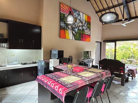 Cozy living room with high ceilings, garden views, kitchenette & large desk.