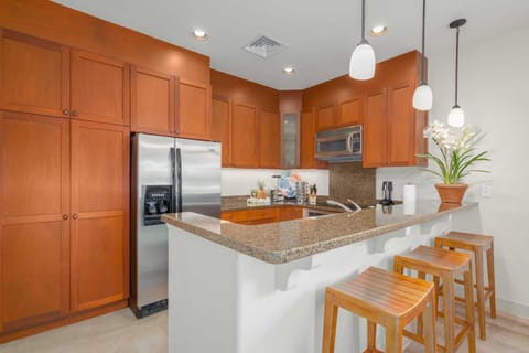 Granite counter tops, hardwood cabinets, stainless steel appliances, bar seating for three.