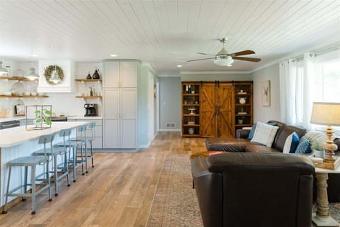 Enjoy our lovely open floorpan which has comfortable couches, island seating, and a TV tucked away for when you need to relax.