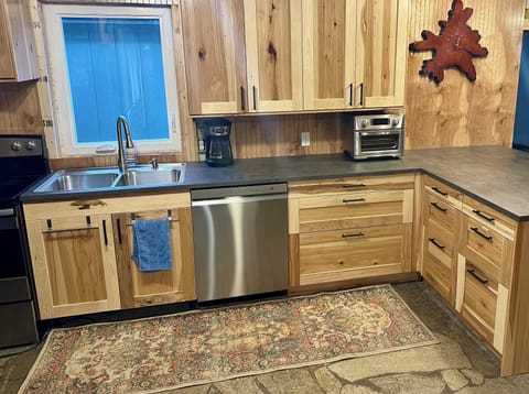 Fully stocked kitchen with oven, fridge, dishwasher and toaster oven.