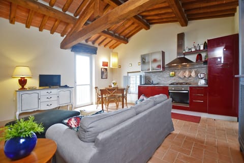 The living room with dining area and kitchen corner