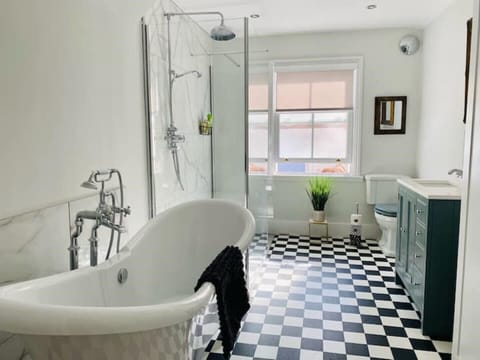 Beautiful spacious bathroom with walk-in shower and roll top bath