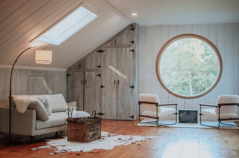 Architecturally unique round window with 4 season nature views