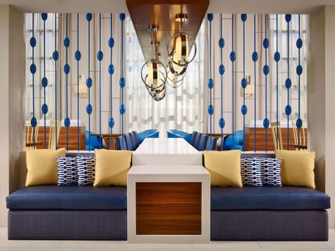 Sink into plush seating under glowing statement pendants.