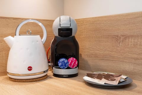 A countertop setup including a kettle and coffee machine, offering a welcoming touch.