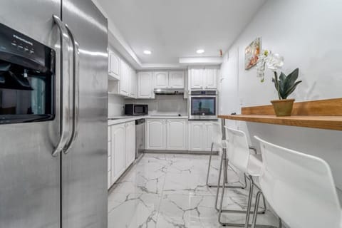 Luxury kitchen featuring modern appliances, elegant marble surfaces, and sophisticated design