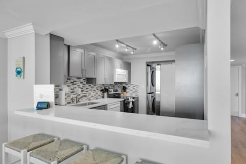 Breakfast bar. Full size stackable washer/dryer.