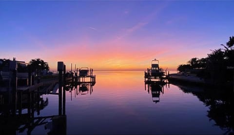 Water like glass mirrors the colorful sunrise…