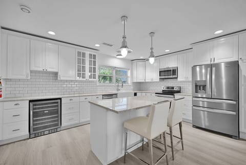 Modern kitchen with new appliances and breakfast bar that seats 2