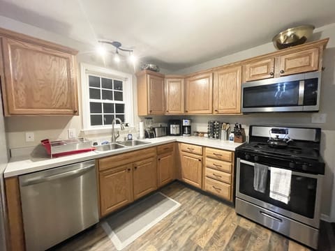 Well-equipped kitchen with dinnerware, pots, pans, toaster, utensils... and more