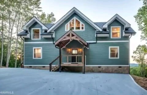 Large parking area for up to 5 vehicles and a covered entry porch. 