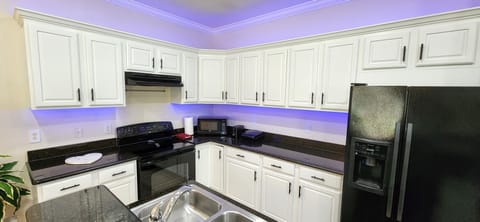 Fully stocked kitchen,  granite countertops, crown molding and led lights