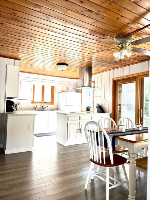 Kitchen with eat-in area. Through the sliders, there is the deck w/ more seating